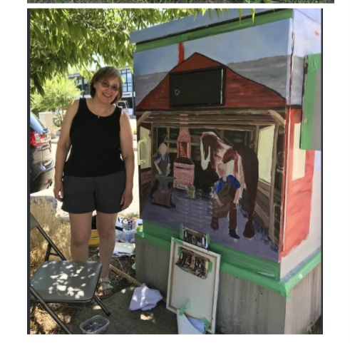 Artist Ruth Clark with her contribution to the "Outside the Box Mural Program".