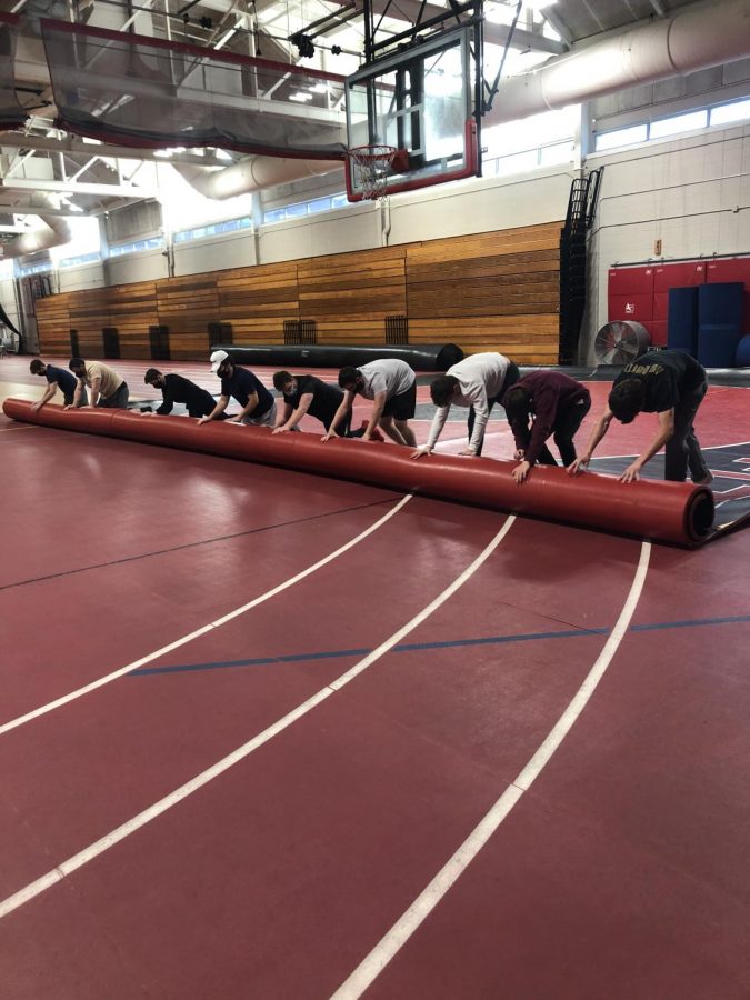 RMHS wrestlers prepare for practice on the main floor of the fieldhouse.