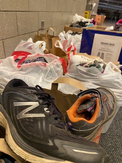 Donated+sneakers+filled+bins+in+the+RMHS+lobby.