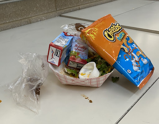 A students lunch trash left behind on a table on Main Street. 