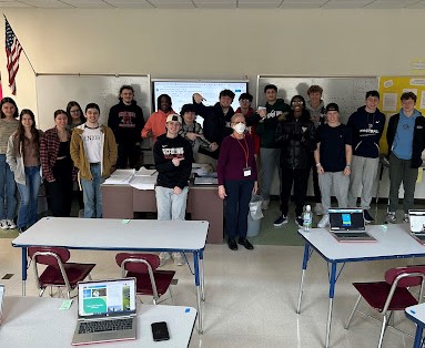 Business teacher Ms. Lynch posing with one of her classes earlier this year.