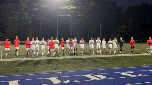 The boys soccer team salutes their fans at the conclusion of their victory over Wilmington.