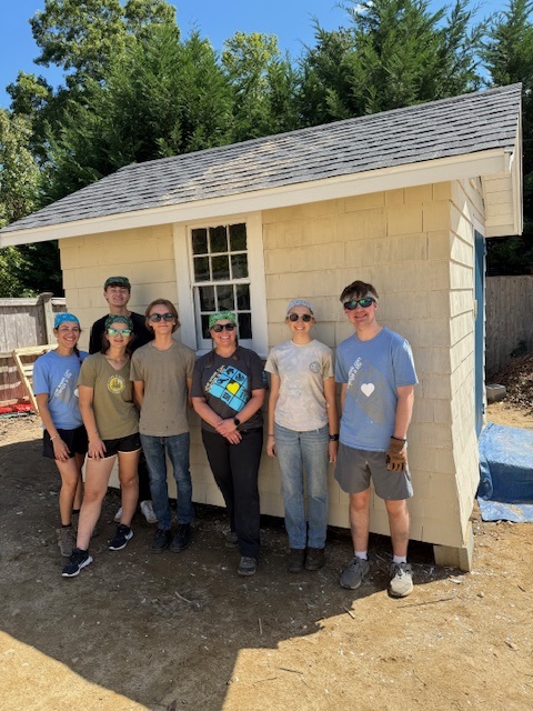 Mrs. Theriault with RMHS student volunteers at a Habitat for Humanity site.